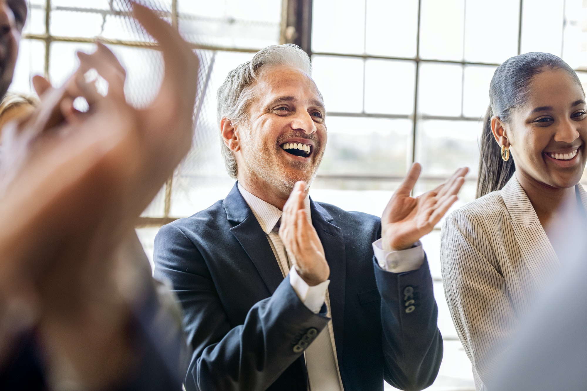 Team of business people clapping